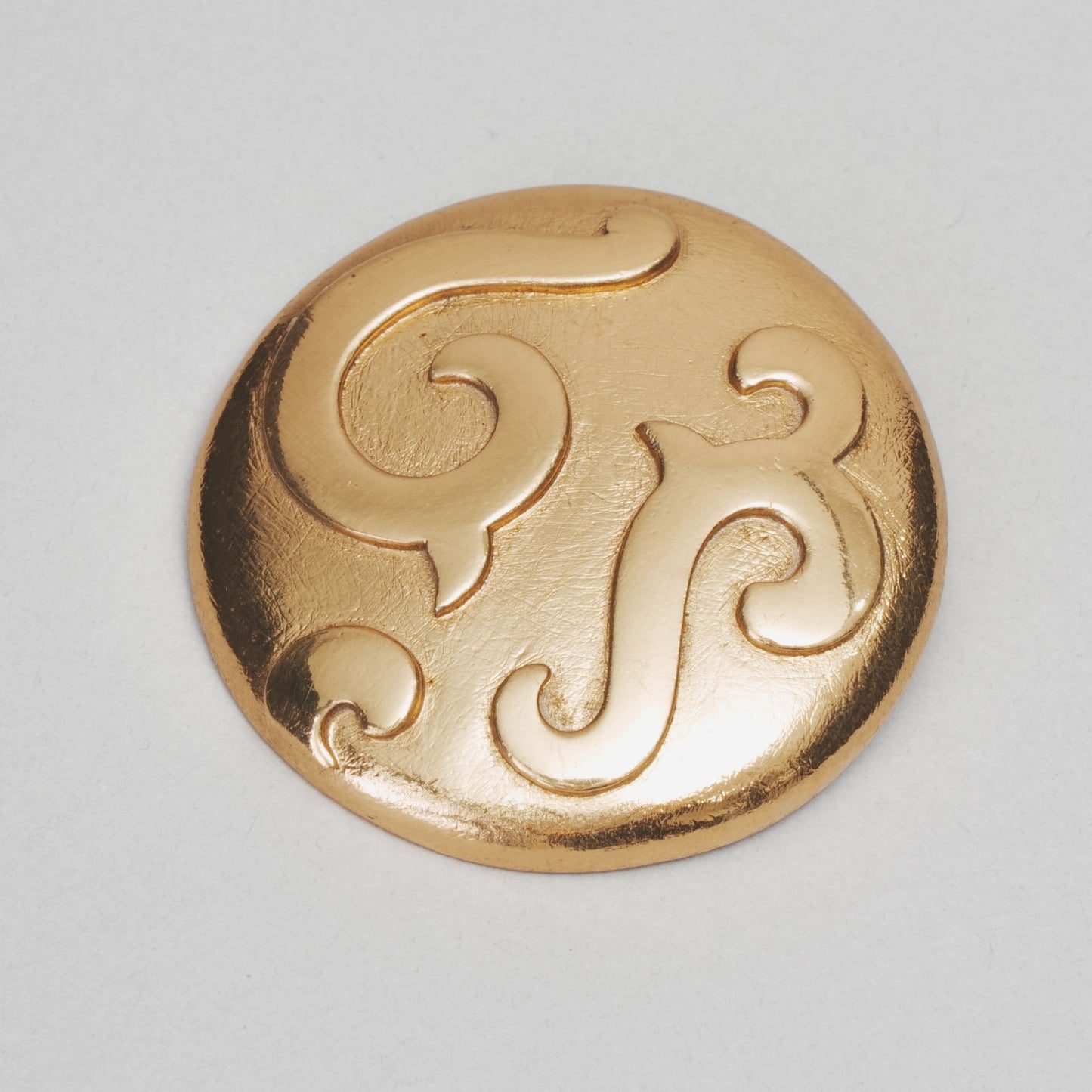 Broche ronde YVES SAINT LAURENT doré